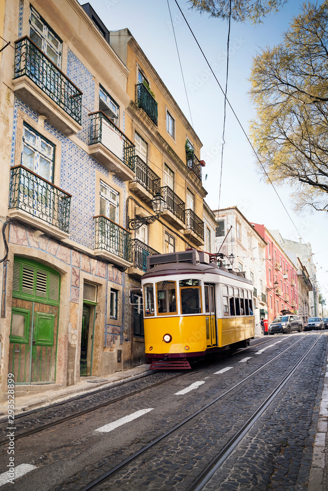 Tourist yellow tram riding around Bairro Alto neighborhood, Lisbon, Portugal