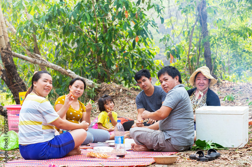 Happy big Asian family having lunch together during the day go picnic in the wood