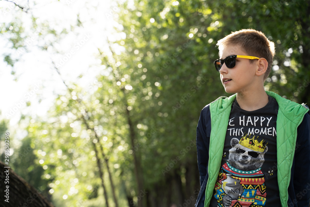 boy in sunglasses on nature background boy in sunglasses on nature background
