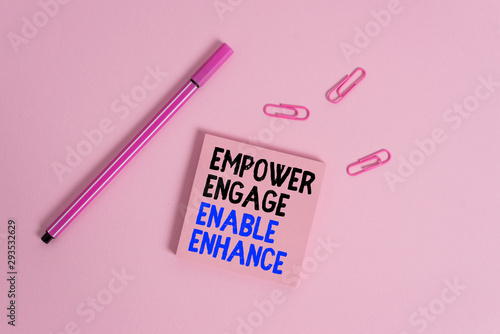 Writing note showing Empower Engage Enable Enhance. Business concept for Empowerment Leadership Motivation Engagement Colored sticky note clips binders gathered pen trendy cool background photo