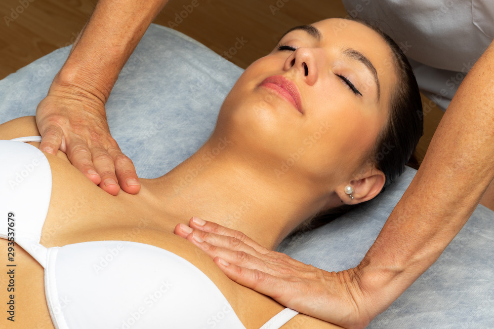 Fototapeta premium Hands applying pressure on collarbone.