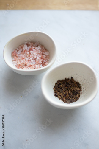 Himalayan salt and pepper on a marble background