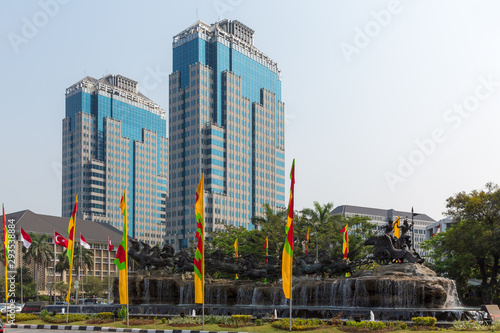 Patung Arjuna Wijaya statue in Central Jakarta, Indonesia. Krishna rides the chariot with Arjuna holding a bow and arrow, pulled by eleven divine horses. photo