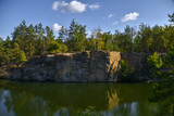 Autumn lake on granite quarry with rocks