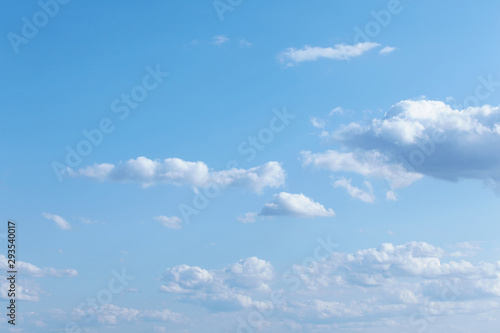 Blue sky with tiny and fluffy clouds.