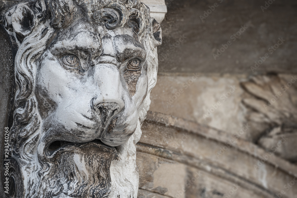 Ancient decoration element of scary lion head at roof of Basilica San Marco and Doge Palace  in Venice, Italy
