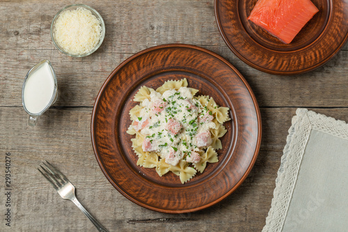 Pasta Farfalle with smoked salmon in cream sauce. The view from the top. Copy space.