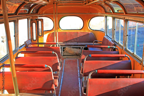 old yellow bus in vintage style on a yellow background. Urban transport. Light vintage antique grunge texture. Antique vintage grunge texture pattern. Blue sky.