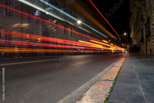 Street cars traffic light trails long exposure photo from the pavement. Long exposure photography concept.