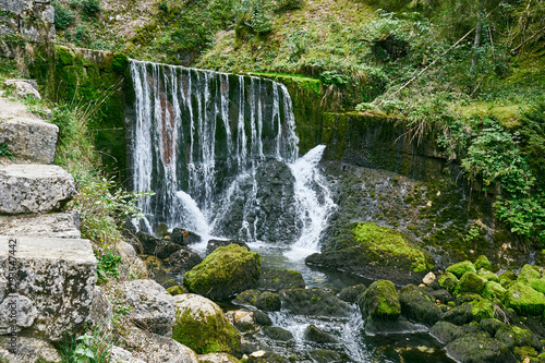 Waterfall at Source du Doubs Mouthe Franche Comté France with Green Plants photo