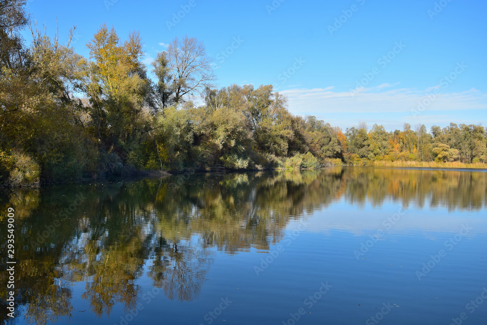 Beautiful autumn landscape with a lake and trees.