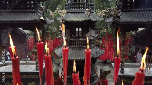 Red candles burning in a taoist temple in QingChengShan, Sichuan Province, China photo