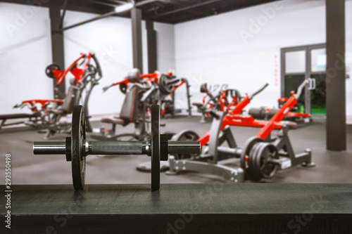 Gym interior and dumbbells on board with free space for your decoration. 