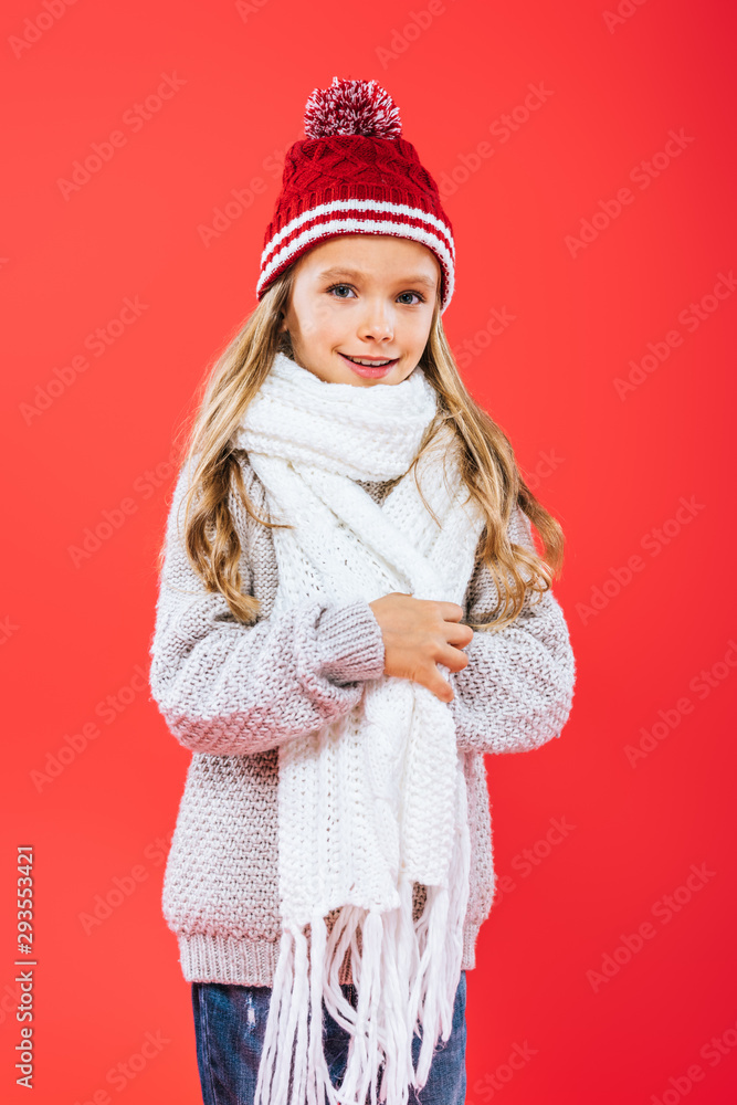 smiling kid in hat and scarf isolated on red smiling kid in hat and scarf isolated on red