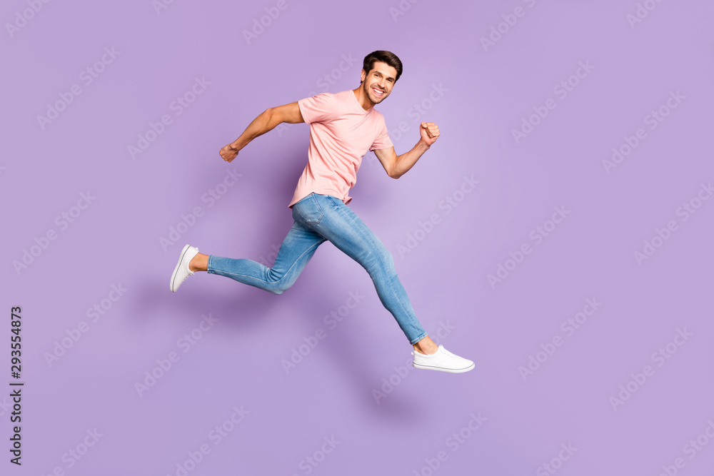 Full body photo of amazing guy jumping high running to shopping center wear casual outfit isolated on purple color background