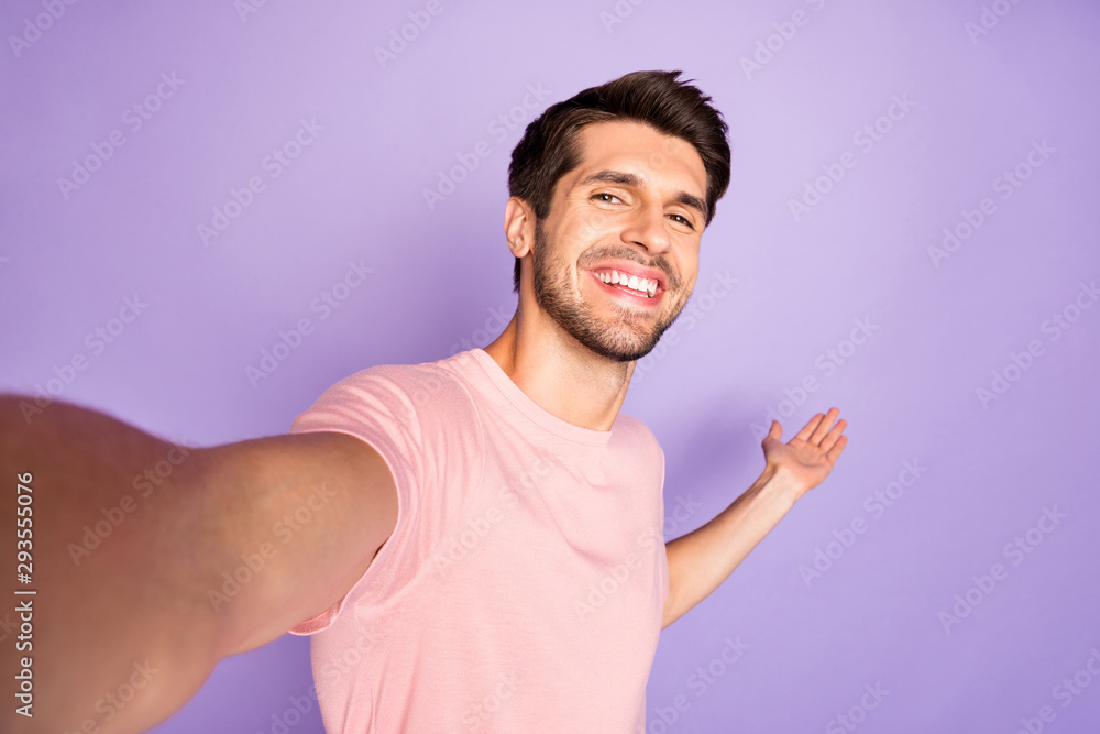 Self-portrait of his he nice attractive cheerful cheery glad bearded guy  wearing pink tshirt showing copy space inviting follow isolated on violet  purple lilac pastel color background Photos