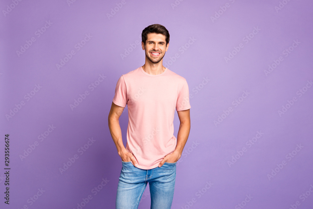 Portrait of his he nice attractive lovely glad content cheerful cheery guy wearing pink tshirt holding hands in pockets enjoying life isolated over violet purple lilac pastel color background Portrait of his he nice attractive lovely glad content cheerful cheery guy wearing pink tshirt holding hands in pockets enjoying life isolated over violet purple lilac pastel color background