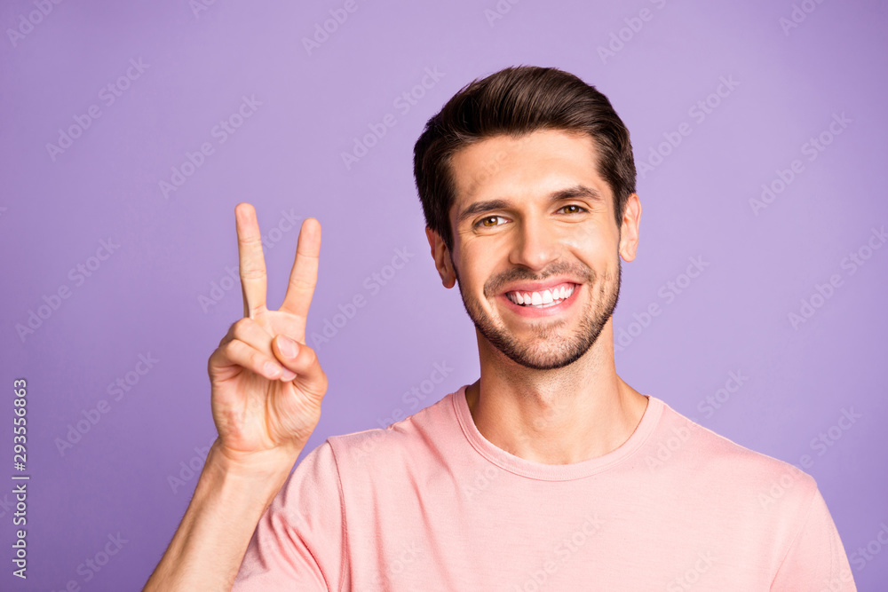 Close-up portrait of his he nice attractive cute cheerful cheery glad bearded brunet guy wearing pink tshirt showing v-sign isolated over violet purple lilac pastel color background Close-up portrait of his he nice attractive cute cheerful cheery glad bearded brunet guy wearing pink tshirt showing v-sign isolated over violet purple lilac pastel color background
