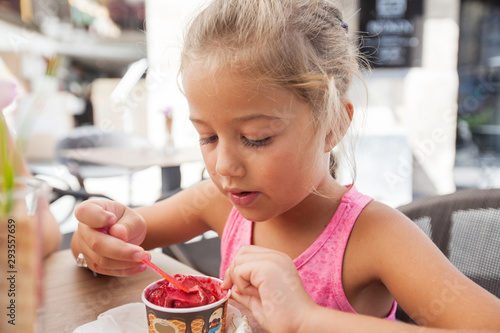 Cute Little Girl Eating Ice Cream Outdoor Cafe