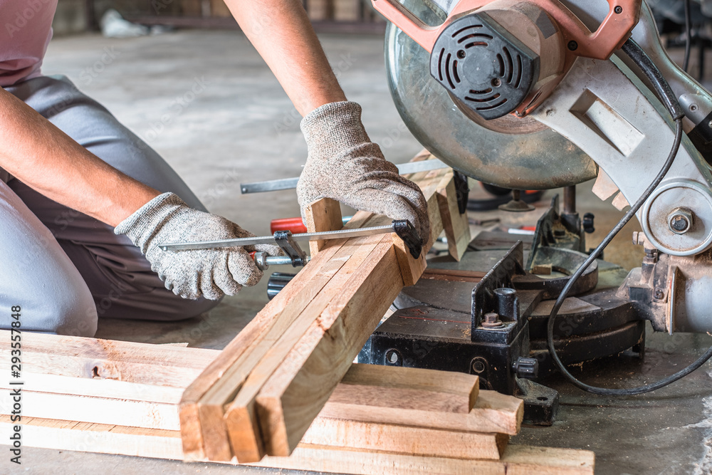 Close up of carpenter hand usie F clamp to group timber in wood working workshop. Wood working tools. Close up of carpenter hand usie F clamp to group timber in wood working workshop. Wood working tools.