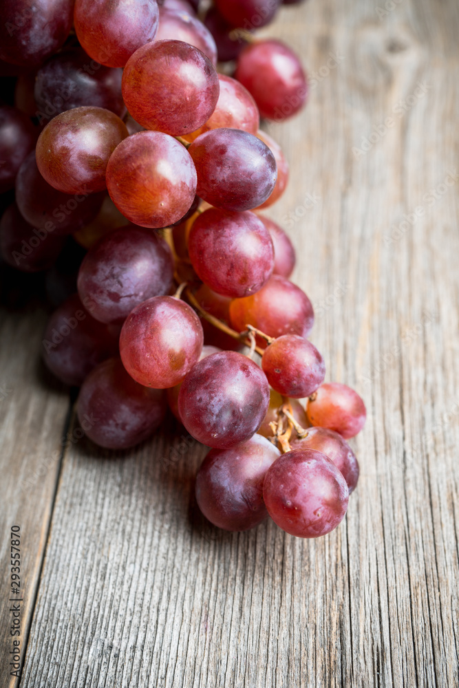 Ripe red grape on the rustic background. Selective focus. Shallow depth of field. Ripe red grape on the rustic background. Selective focus. Shallow depth of field.