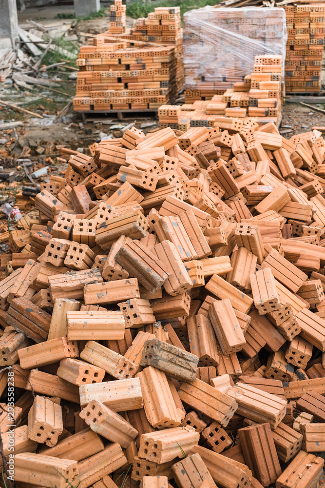 Pile of of bricks placing in row prepared for new house construction Pile of of bricks placing in row prepared for new house construction