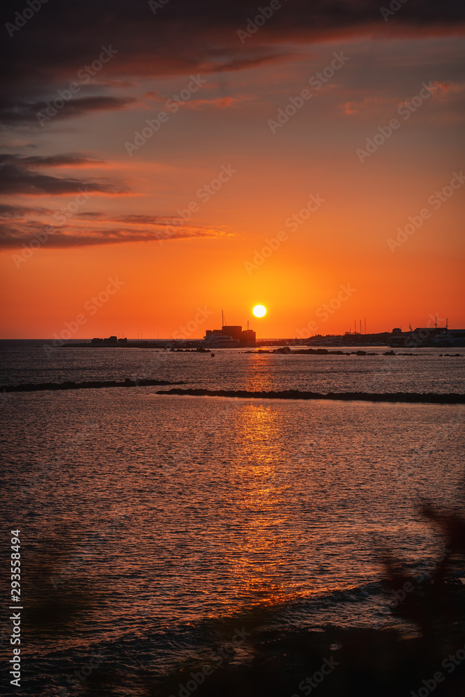 Beautiful sunset view over the Paphos old castle, harbor and the sea in Paphos Cyprus 