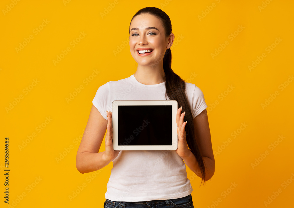 Smiling Young Lady Showing Empty Tablet Screen, Studio Shot Smiling Young Lady Showing Empty Tablet Screen, Studio Shot