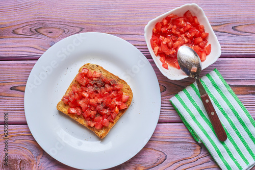Toasted tomato toast. Vegetarian bruschetta with fresh tomatoes and pepper on white bread.
