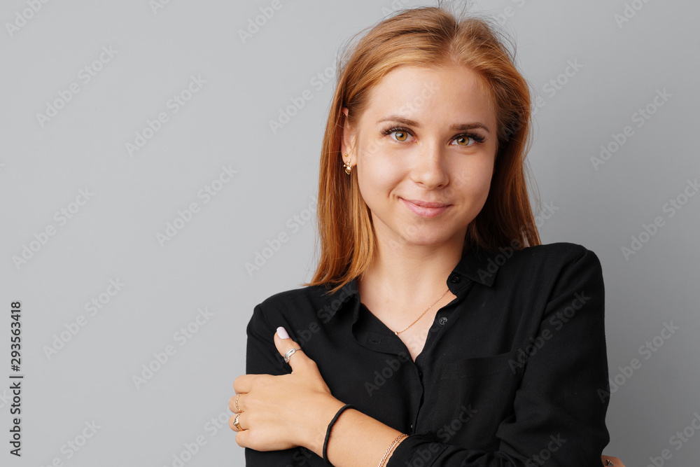 Beautiful young woman teenager posing over a grey background Beautiful young woman teenager posing over a grey background