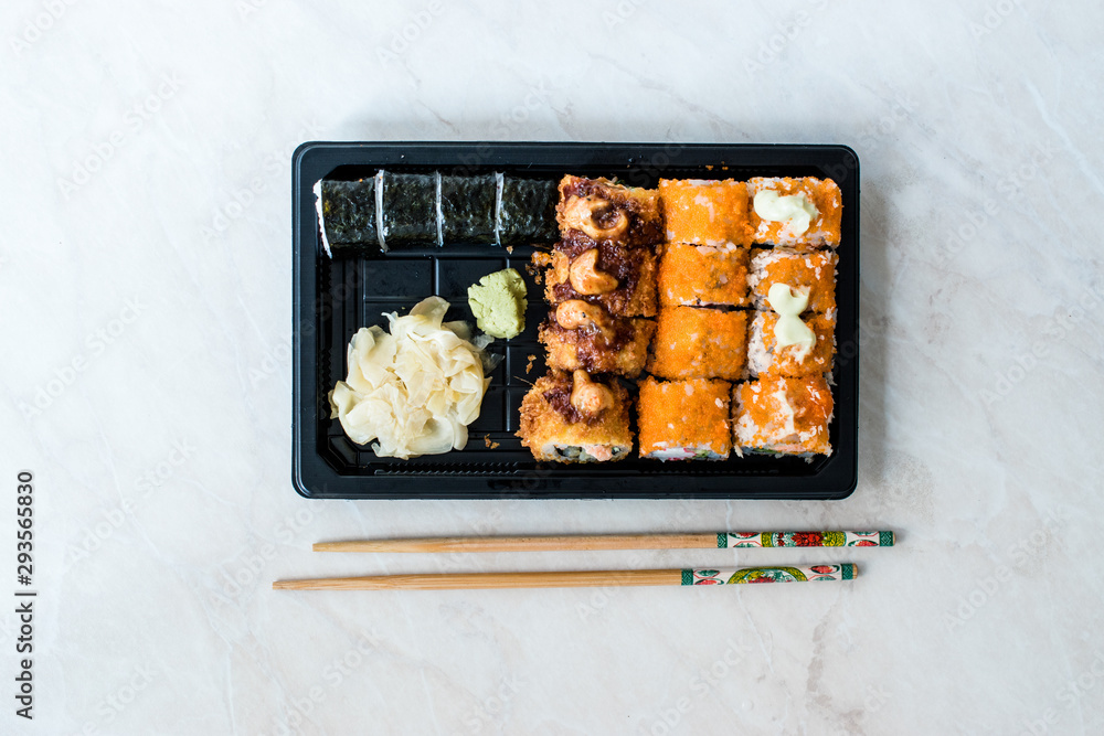 Sushi Set in Plastic Container Box / Package. California Roll, New York Roll, Boom Roll, Ginger, Wasabi and Soy Sauce. Sushi Set in Plastic Container Box / Package. California Roll, New York Roll, Boom Roll, Ginger, Wasabi and Soy Sauce.