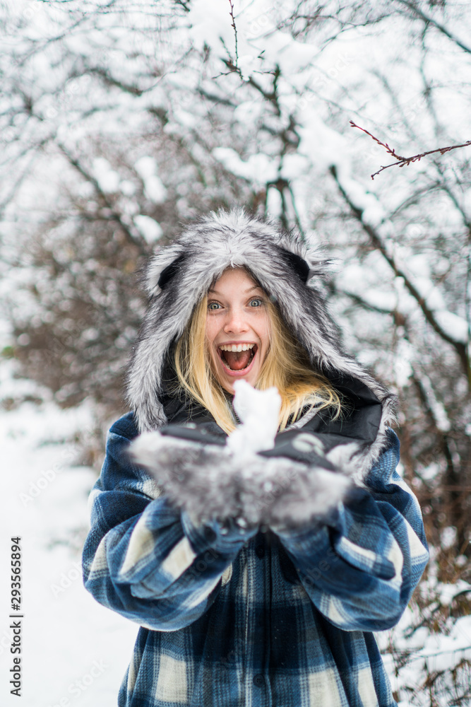 Wintertime. Happy winter girl. Girl playing with snow in park. Happy holiday. Woman playing with snowballs. Winter and snowy weather. Winter nature background. Wintertime. Happy winter girl. Girl playing with snow in park. Happy holiday. Woman playing with snowballs. Winter and snowy weather. Winter nature background.