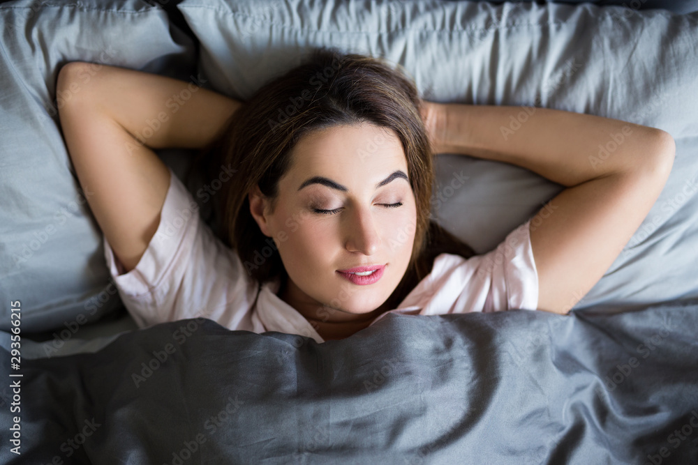 morning concept - top view of young sleeping woman in bed morning concept - top view of young sleeping woman in bed