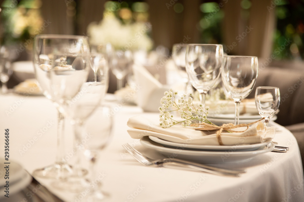 Table setting set with flowers. Modern and elegant decoration of table set for celebration with white utensil. Table setting set with flowers. Modern and elegant decoration of table set for celebration with white utensil.