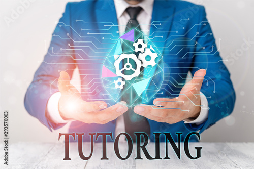 Writing note showing Tutoring. Business concept for An act of a demonstrating employed to administer knowledge to someone Male human wear formal suit presenting using smart device photo