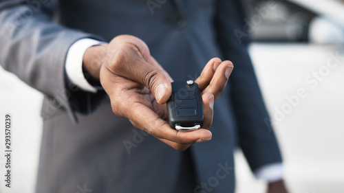 Car rental concept. Man holding car key in hand