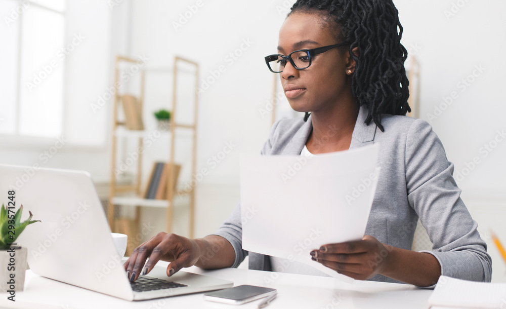 Black Office Girl Using Laptop Working With Papers At Workplace Black Office Girl Using Laptop Working With Papers At Workplace