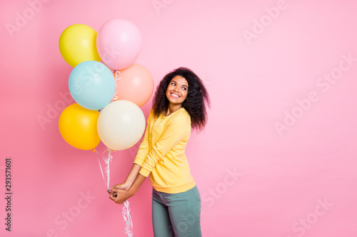 Portrait of cheerful funky youth girl hold many balons feel content on her birthday 8-march wear trendy clothes isolated over pastel pink color background photo