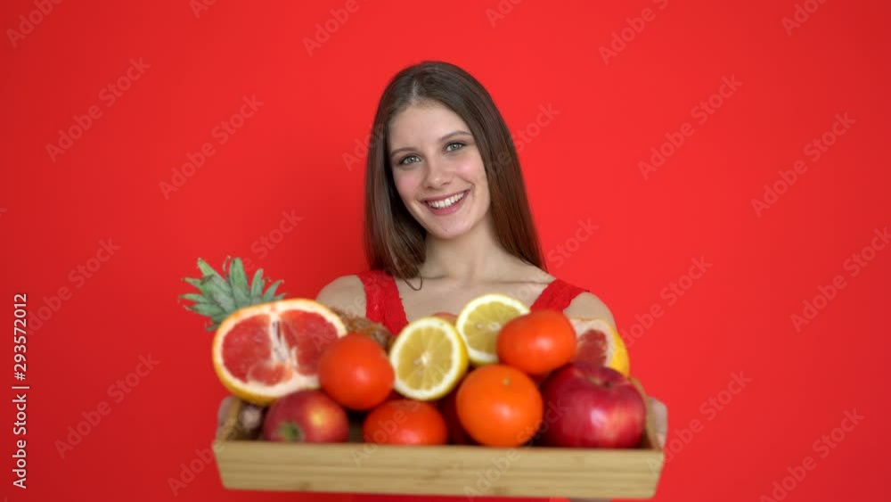 Fruit, concept of healthy food, lifestyle, diet, health care. Vitamin C fruits, beautiful slim female girl woman showing box of fresh fruit. citrus orange lemon pineapple apple for immunity, 4 K Fruit, concept of healthy food, lifestyle, diet, health care. Vitamin C fruits, beautiful slim female girl woman showing box of fresh fruit. citrus orange lemon pineapple apple for immunity, 4 K