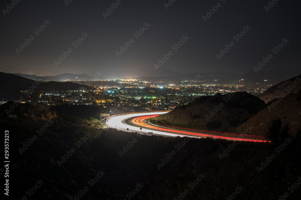 Fototapeta Night view of Simi Valley and route 118 commuter freeway traffic near Los Angeles in Ventura County, California.