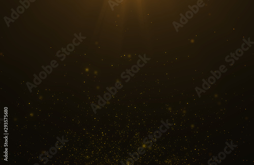 Abstract background of flickering gold particles and light flare