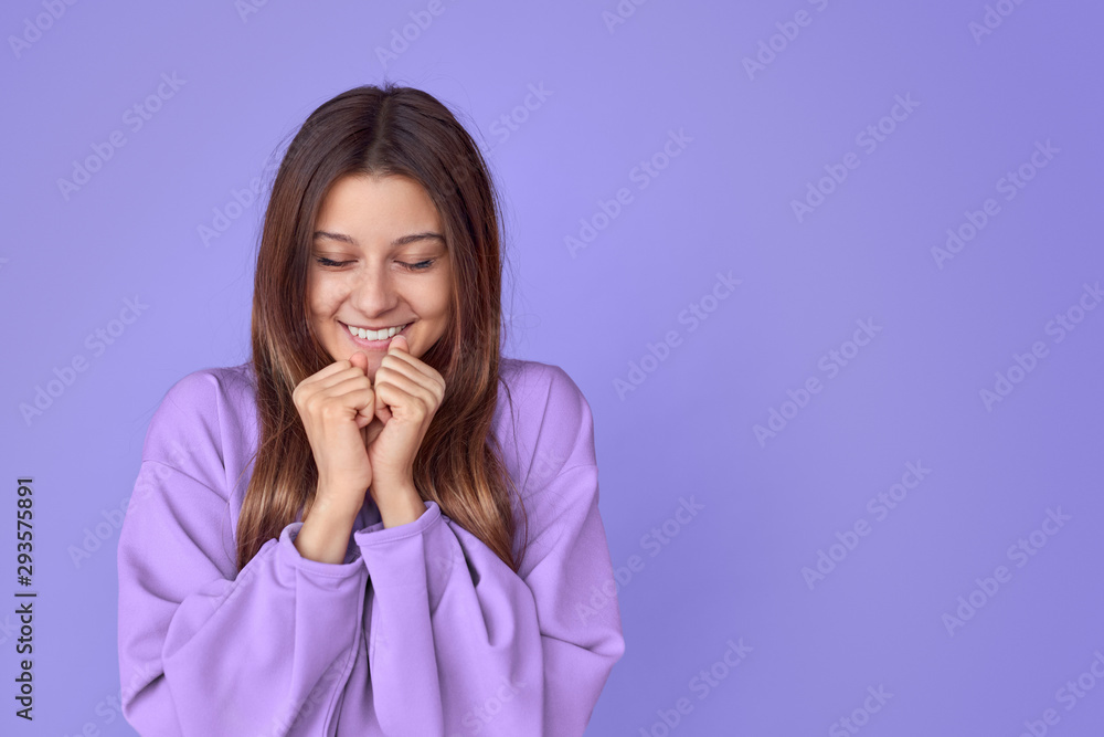 Smiling woman making wish with closed eyes Smiling woman making wish with closed eyes