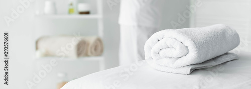 panoramic shot of white towel on massage mat in spa