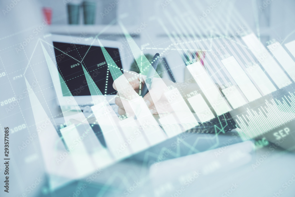 Fototapeta premium Financial graph displayed on woman's hand taking notes background. Concept of research. Double exposure