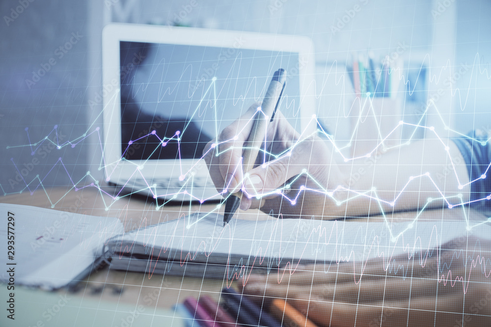 Financial forex charts displayed on woman's hand taking notes background. Concept of research. Double exposure Financial forex charts displayed on woman's hand taking notes background. Concept of research. Double exposure