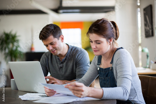 Young adult couple working on finance application together