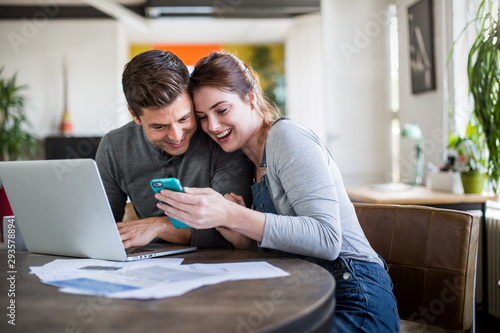 Young adult couple celebrating getting a mortgage together photo