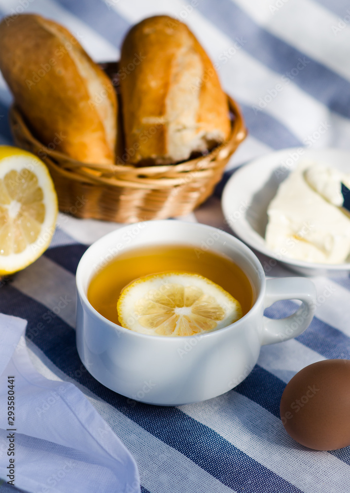 Traditional breakfast in the open air. Green tea in the cup for summer breakfast Traditional breakfast in the open air. Green tea in the cup for summer breakfast