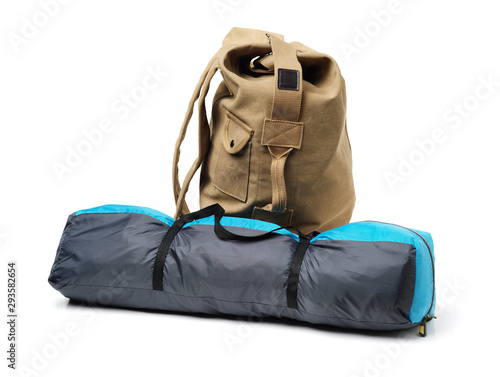 Tourist tent and backpack from fabric of color khaki on white background