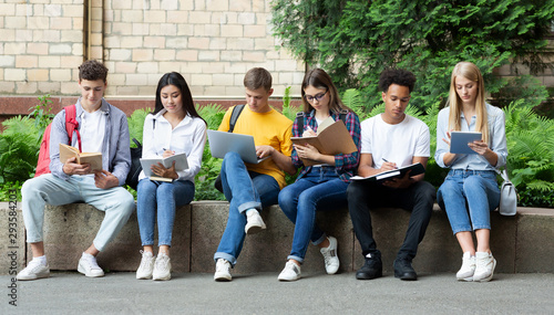 University life. Friends preparing for classes in campus